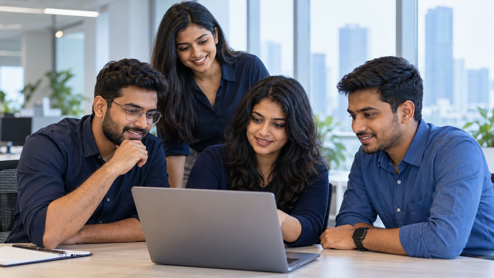DataRidges team collaborating around a laptop